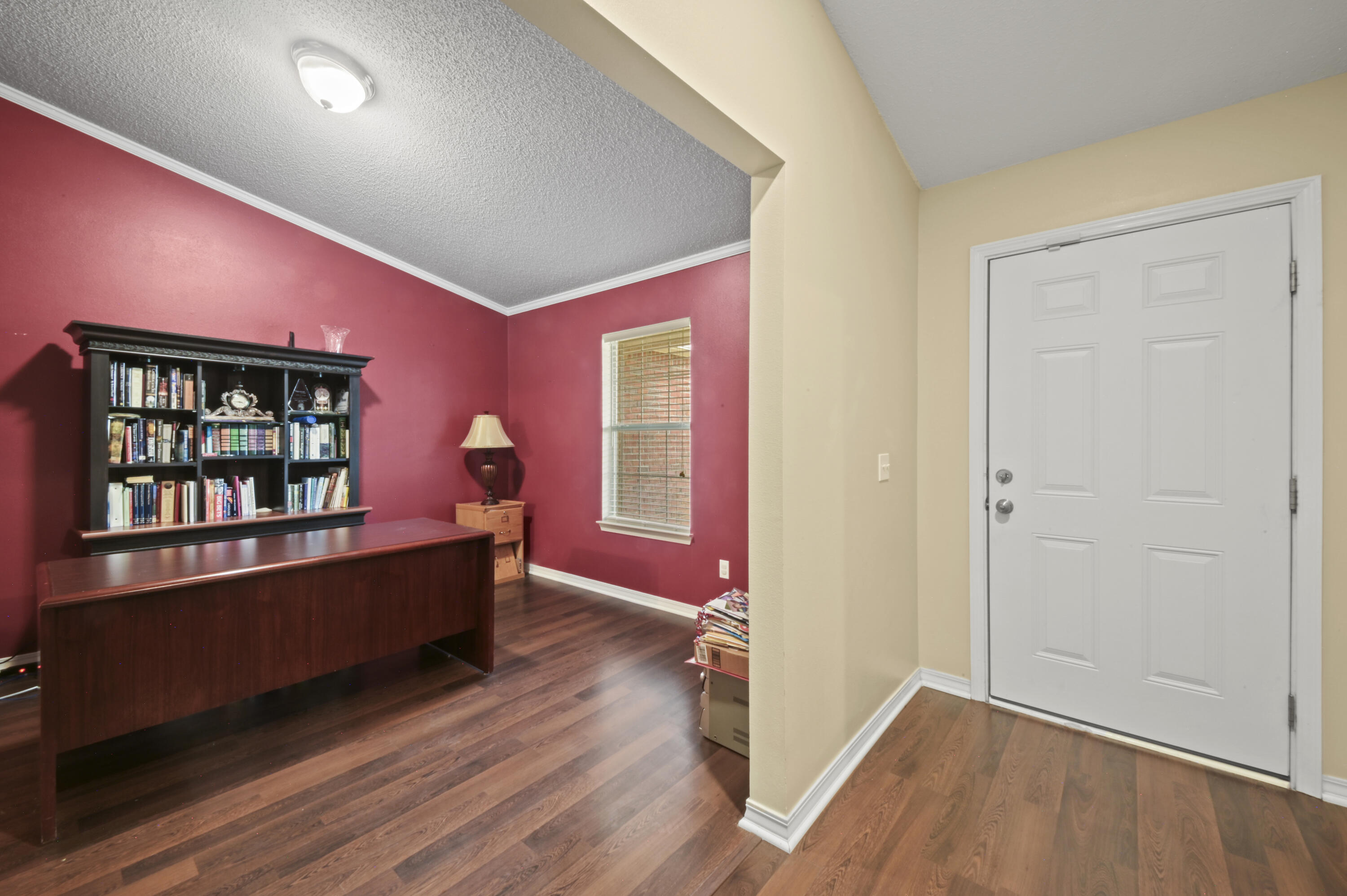 334 Egan Drive Crestview, FL 32536 - Photo 6 of 33 an empty room with wooden floor and windows