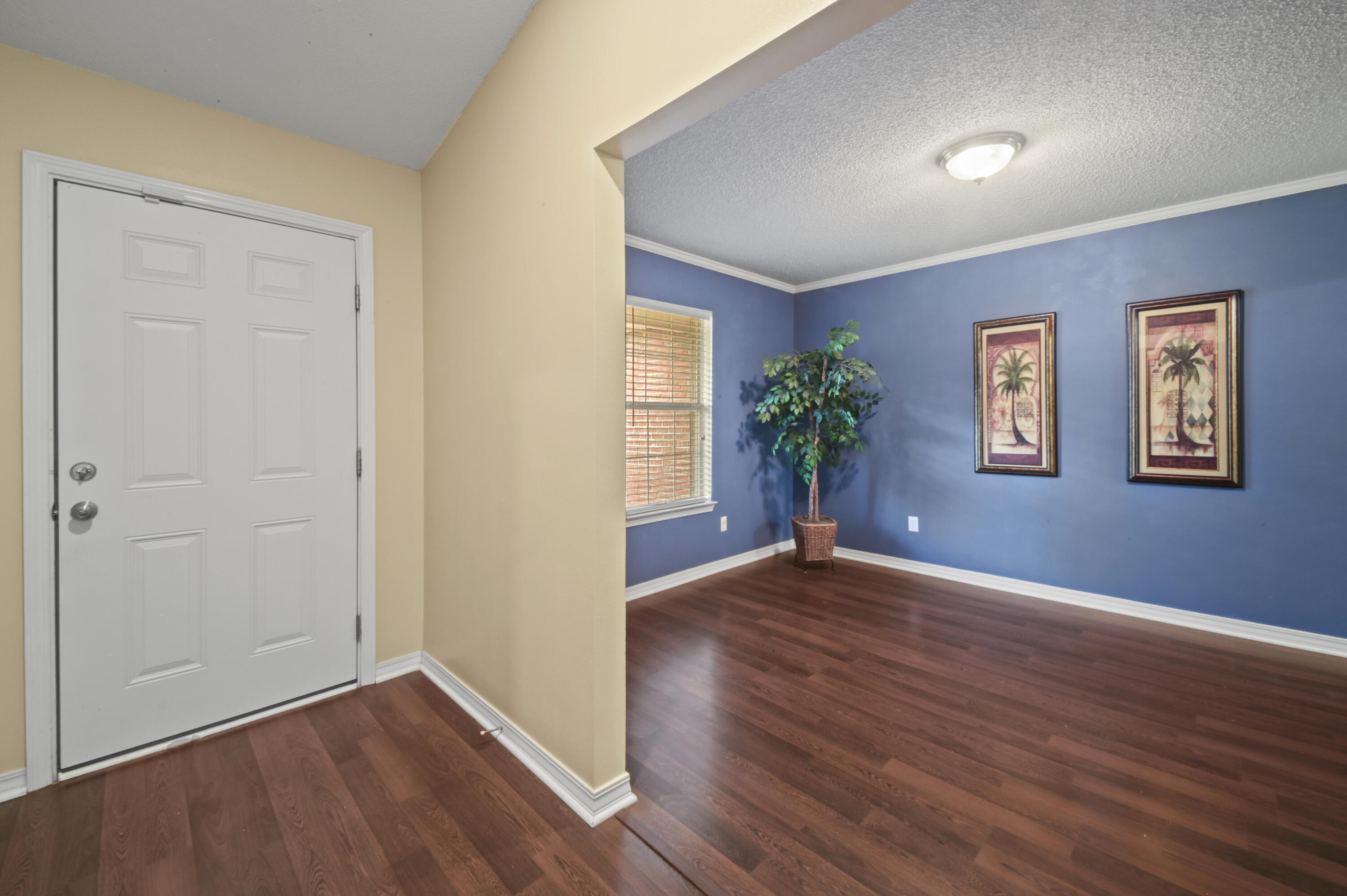 334 Egan Drive Crestview, FL 32536 - Photo 7 of 33 a view of an empty room with wooden floor and a window