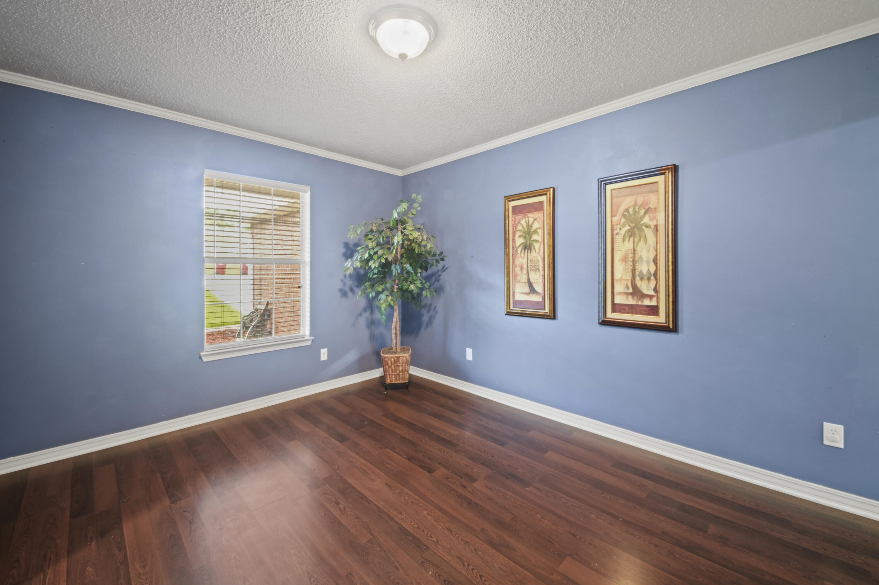 334 Egan Drive Crestview, FL 32536 - Photo 8 of 33 a view of an empty room with window and wooden floor