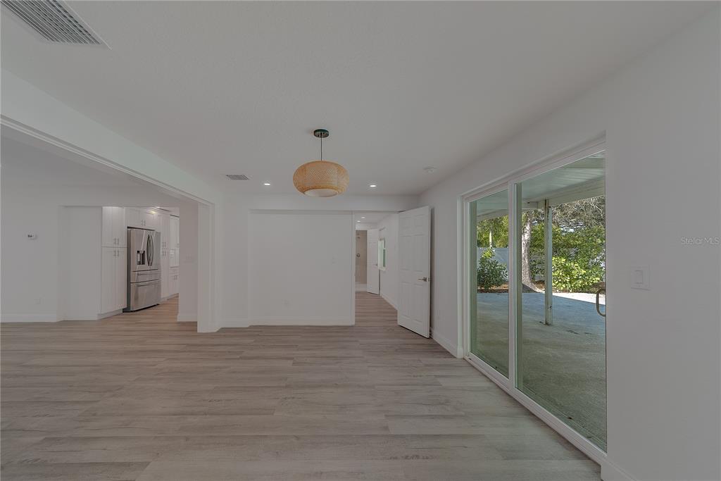 1152 Jackmar Road Dunedin, FL 34698 - Photo 25 of 60 a view of an empty room with wooden floor and a window