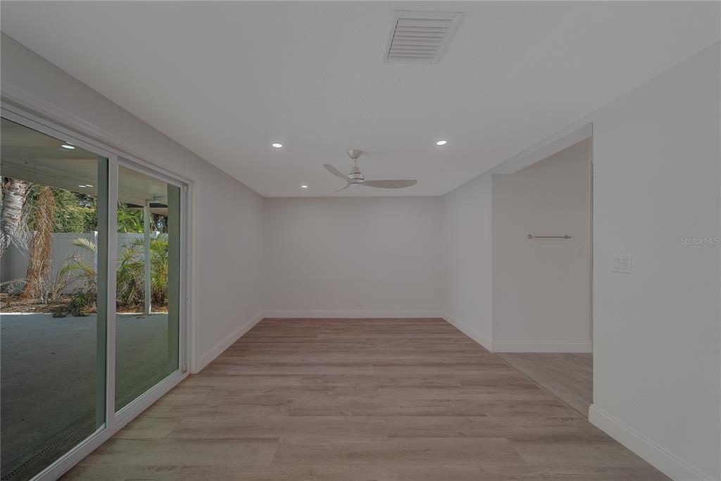 1152 Jackmar Road Dunedin, FL 34698 - Photo 26 of 60 an empty room with wooden floor and windows