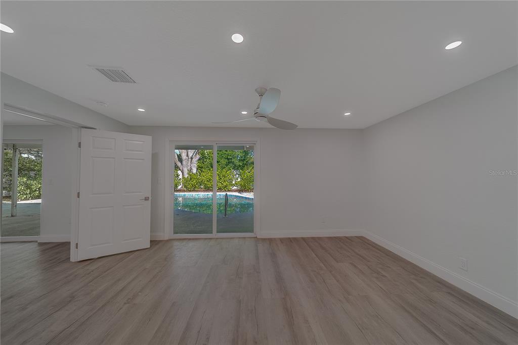 1152 Jackmar Road Dunedin, FL 34698 - Photo 27 of 60 wooden floor in an empty room with a window