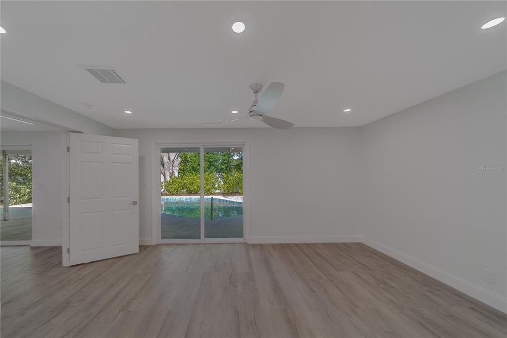 1152 Jackmar Road Dunedin, FL 34698 - Photo 29 of 60 an empty room with wooden floor and a window