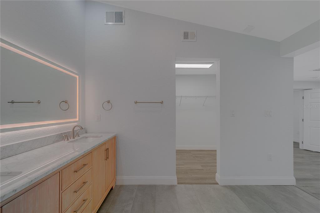 1152 Jackmar Road Dunedin, FL 34698 - Photo 33 of 60 a bathroom with a granite countertop sink and mirror