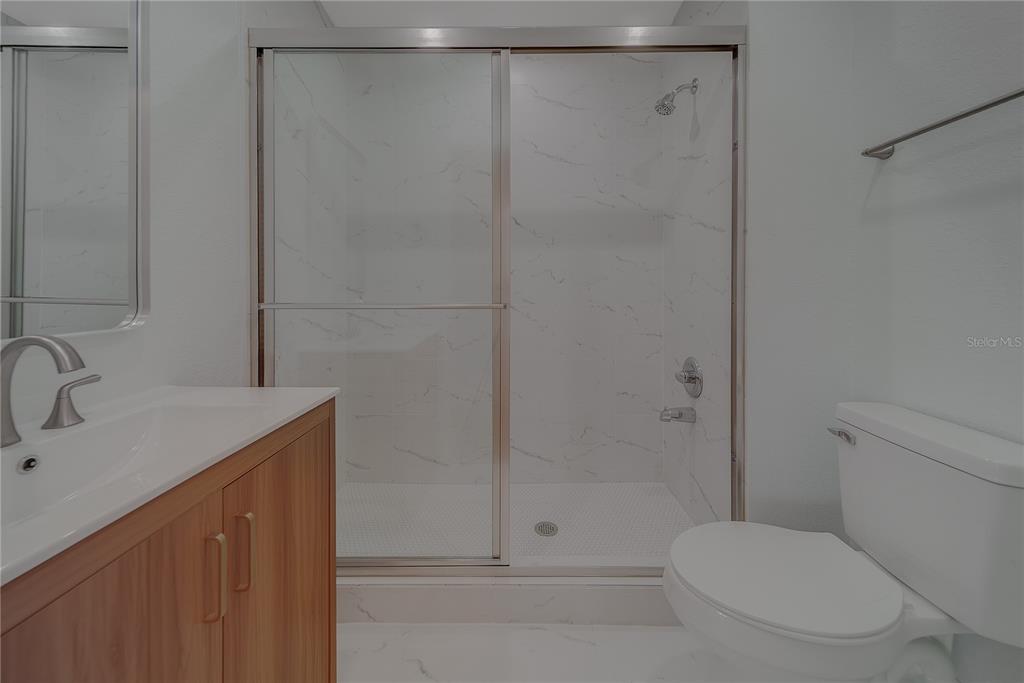 1152 Jackmar Road Dunedin, FL 34698 - Photo 42 of 60 a bathroom with a shower a toilet and sink