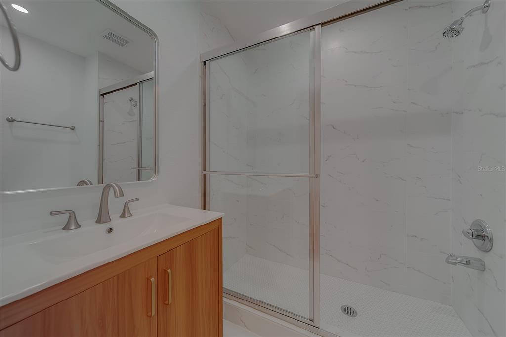 1152 Jackmar Road Dunedin, FL 34698 - Photo 43 of 60 a bathroom with a shower sink and vanity