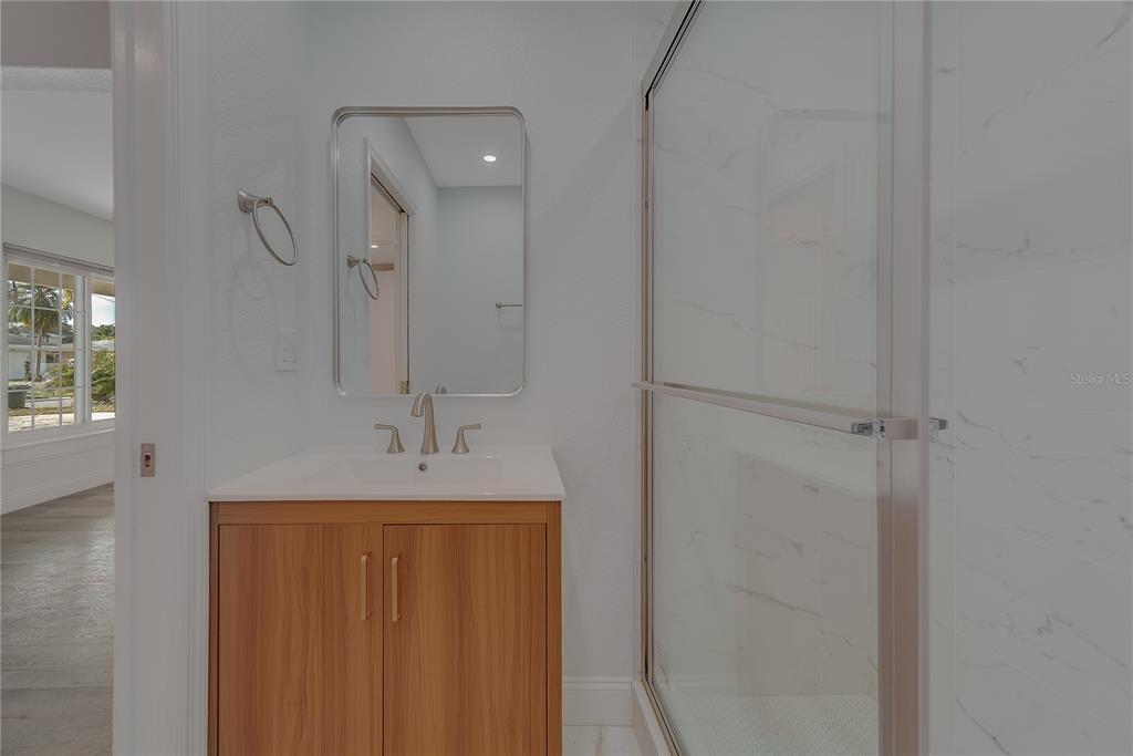 1152 Jackmar Road Dunedin, FL 34698 - Photo 44 of 60 a bathroom with a sink and a mirror