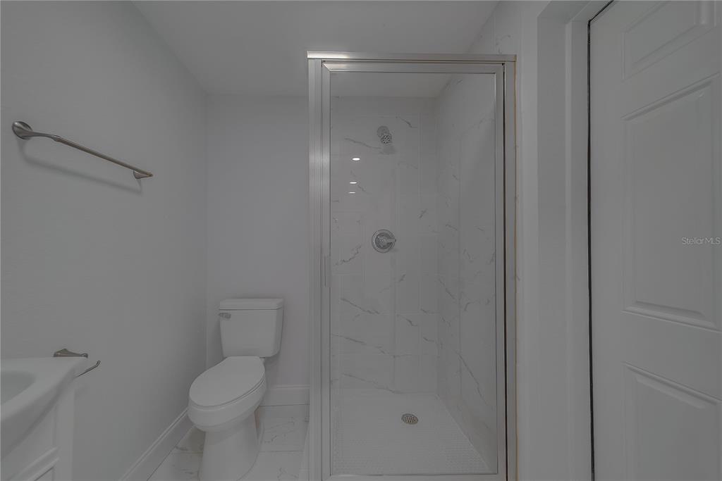 1152 Jackmar Road Dunedin, FL 34698 - Photo 48 of 60 a bathroom with a shower a toilet and sink