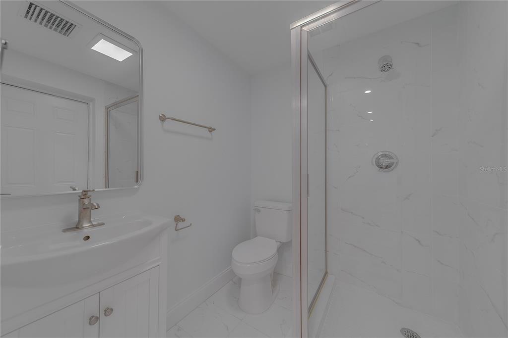 1152 Jackmar Road Dunedin, FL 34698 - Photo 49 of 60 a bathroom with a sink a toilet and shower