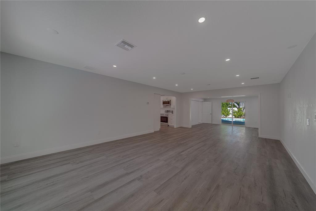 1152 Jackmar Road Dunedin, FL 34698 - Photo 5 of 60 a view of empty room with wooden floor and window