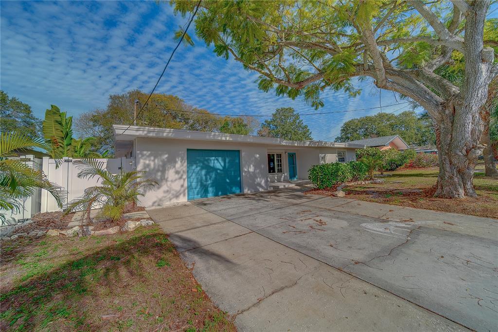 1152 Jackmar Road Dunedin, FL 34698 - Photo 51 of 60 a view of a house with a tree in the background