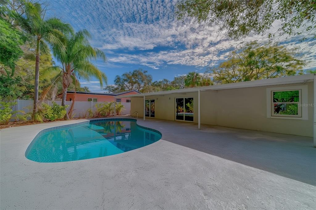 1152 Jackmar Road Dunedin, FL 34698 - Photo 54 of 60 front view of house with a yard and potted plants