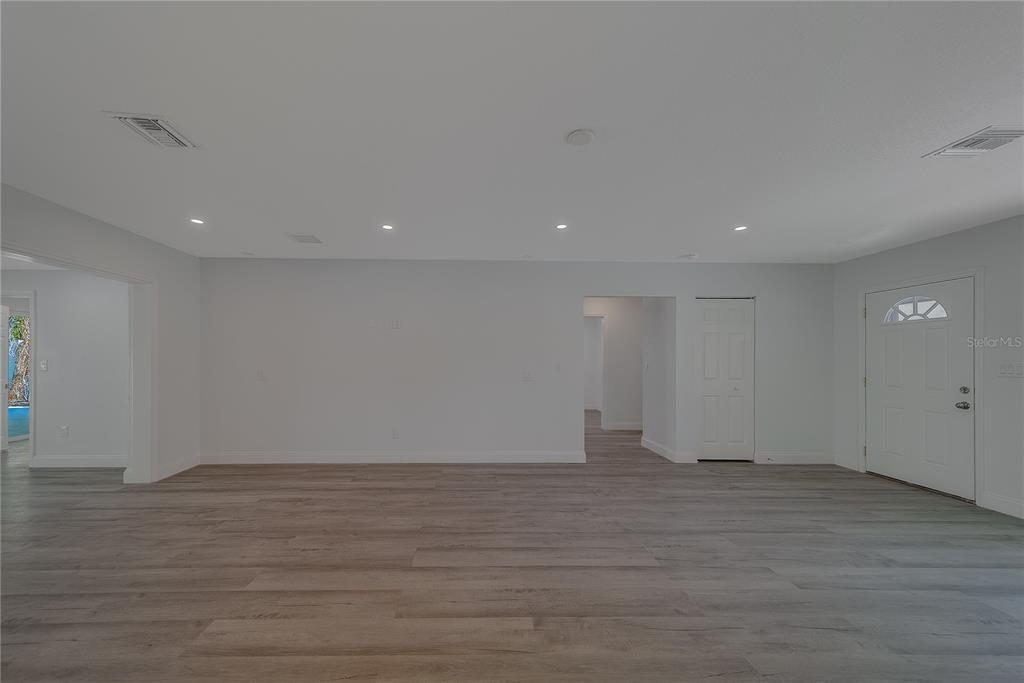 1152 Jackmar Road Dunedin, FL 34698 - Photo 9 of 60 a view of an empty room with wooden floor