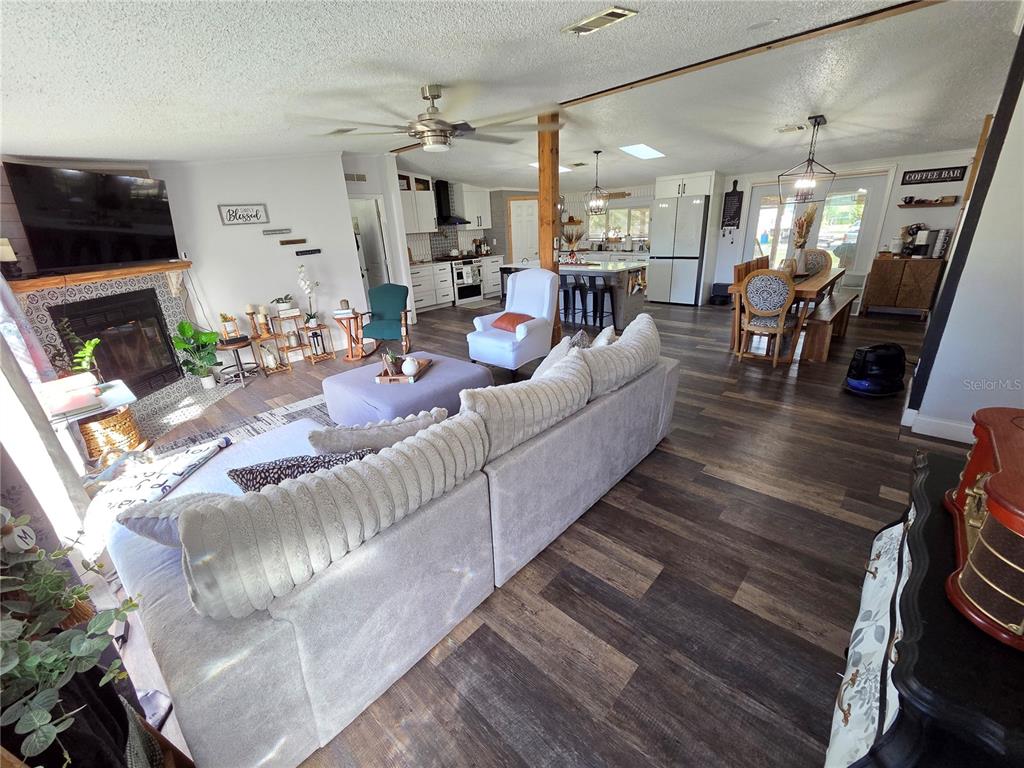 3935 Rambler Avenue St. Cloud, FL 34772 - Photo 11 of 36 a living room with fireplace furniture and a flat screen tv