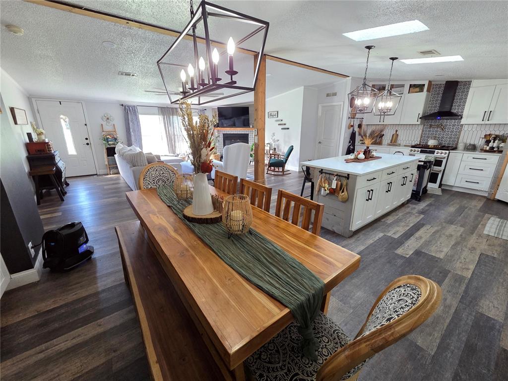 3935 Rambler Avenue St. Cloud, FL 34772 - Photo 13 of 36 a large living room with lots of furniture and kitchen view