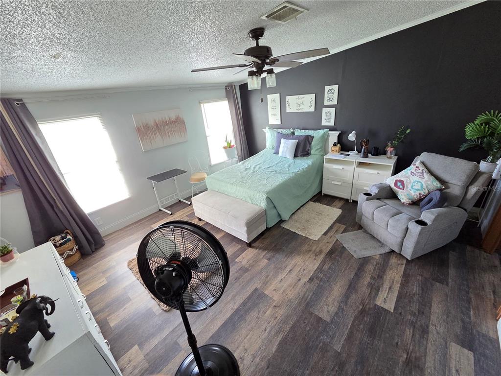 3935 Rambler Avenue St. Cloud, FL 34772 - Photo 15 of 36 a living room with furniture a chandelier and a rug