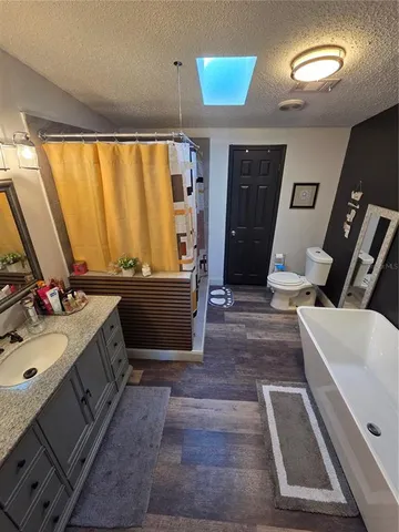 a bathroom with a sink mirror and a bathtub