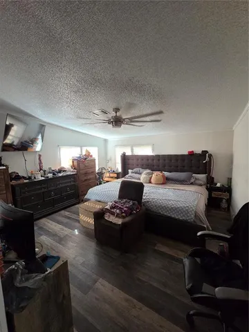 a bedroom with furniture and a wooden floor