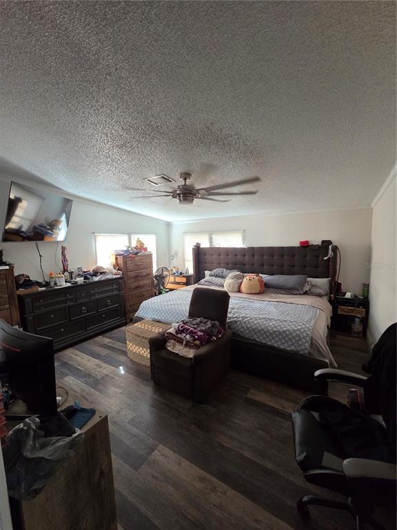 3935 Rambler Avenue St. Cloud, FL 34772 - Photo 20 of 36 a bedroom with furniture and a wooden floor