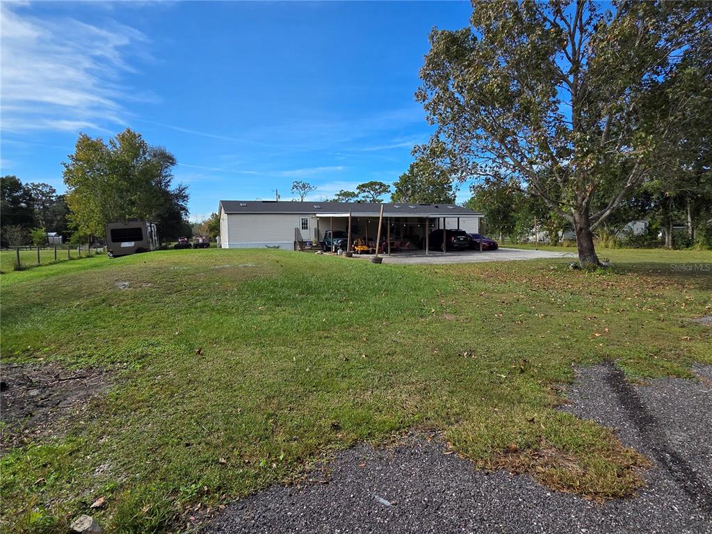 3935 Rambler Avenue St. Cloud, FL 34772 - Photo 31 of 36 a front view of house with yard and green space