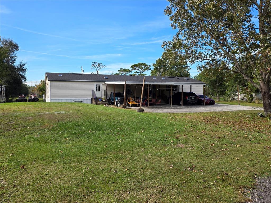 3935 Rambler Avenue St. Cloud, FL 34772 - Photo 32 of 36 a view of a house with a big yard