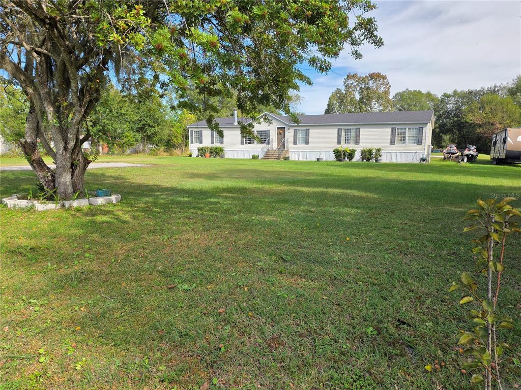 3935 Rambler Avenue St. Cloud, FL 34772 - Photo 5 of 36 a front view of a house with garden
