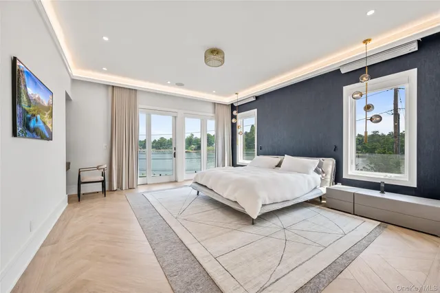 a spacious bedroom with a large bed and a large window