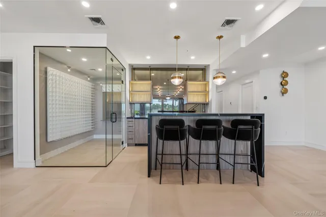 a kitchen with stainless steel appliances kitchen island granite countertop a table and chairs in it