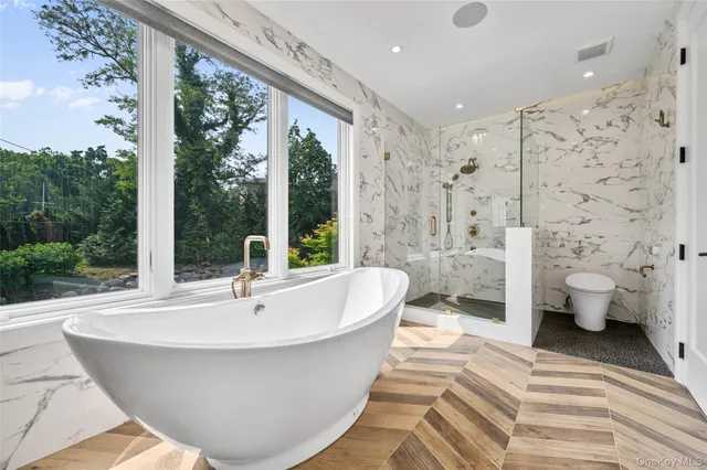 a white bath tub sitting next to a white toilet