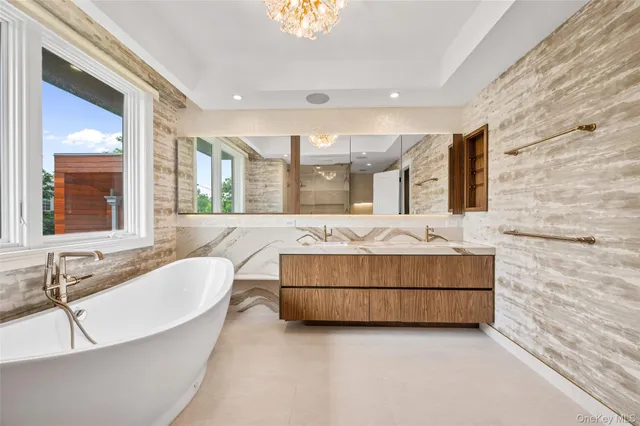 a bathroom with a large tub sink and mirror