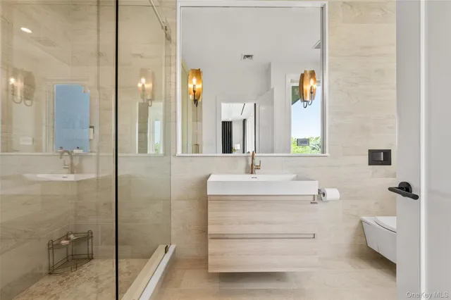 a bathroom with a double vanity sink mirror and toilet