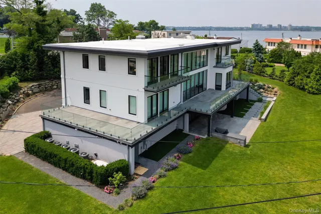 a balcony with wooden floor table and chairs