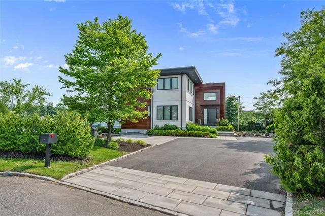 a front view of a house with a yard and a garage