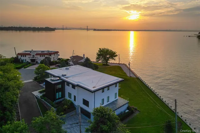 a view of a house with a yard and ocean view