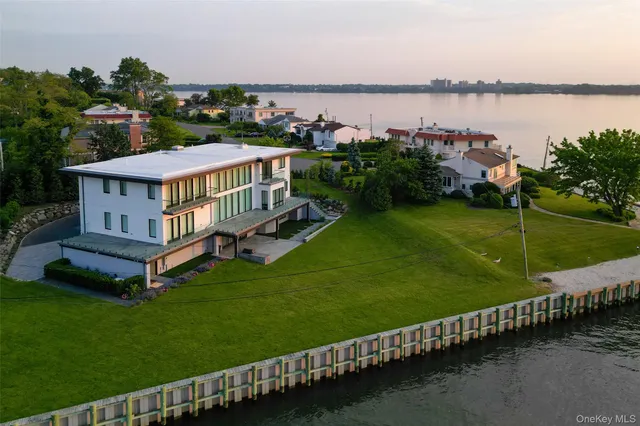 a front view of a house with a garden and plants