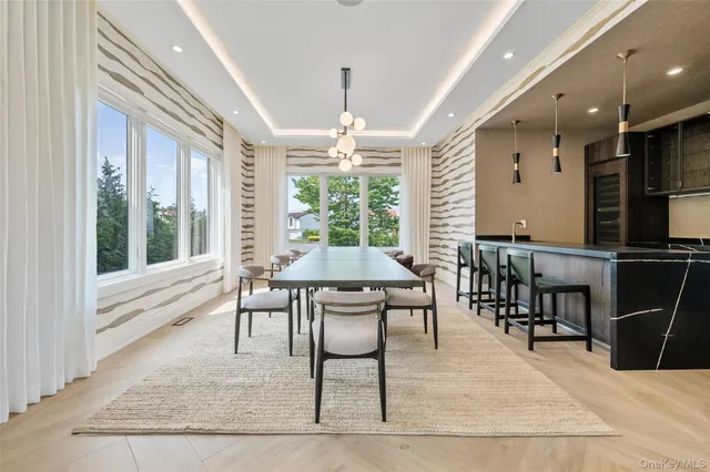 a dining room with wooden floor and window