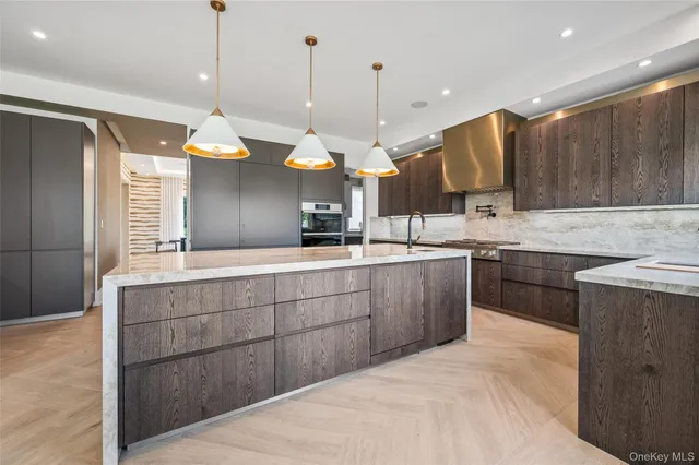 a kitchen with a sink a counter space appliances and cabinets