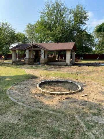 a view of a house with swimming pool and a yard