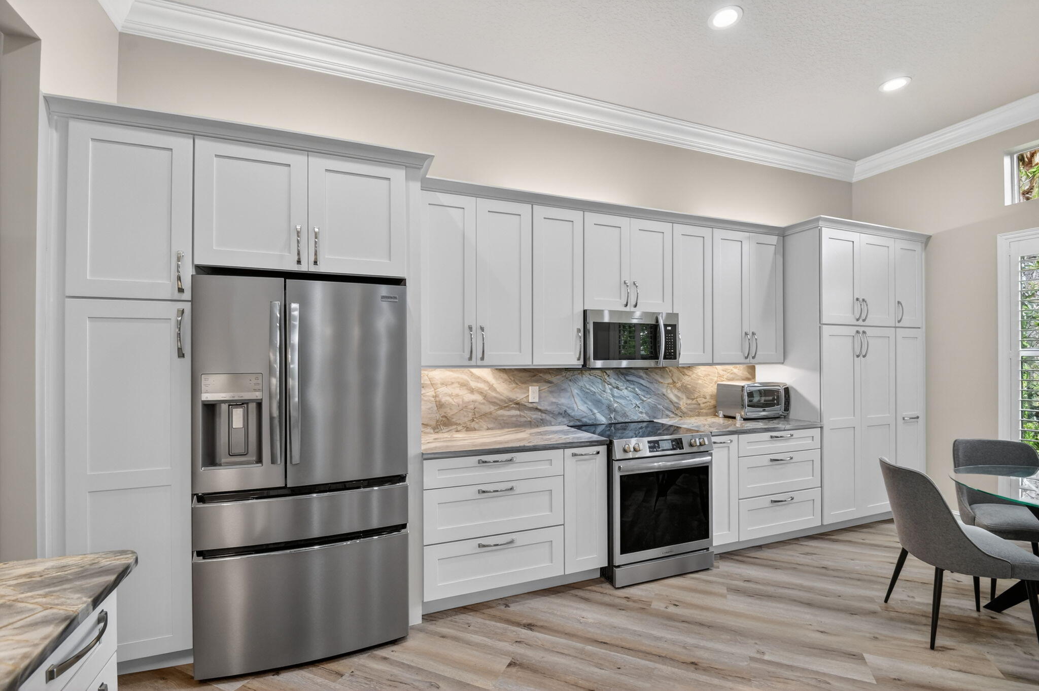 9119 Ribbons Ridge Point Boynton Beach, FL 33473 - Photo 5 of 91 a kitchen with appliances a sink and a refrigerator