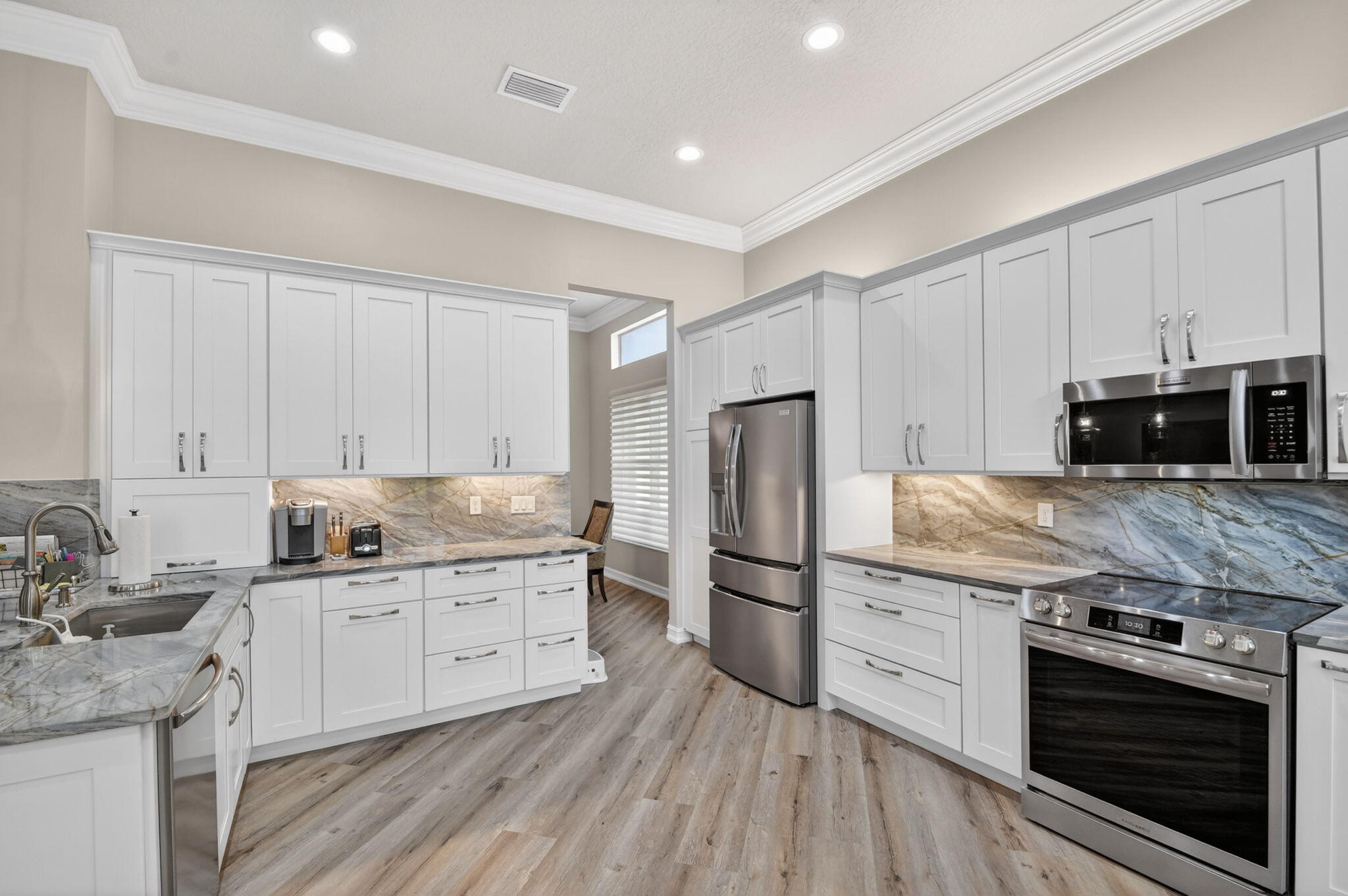 9119 Ribbons Ridge Point Boynton Beach, FL 33473 - Photo 6 of 91 a kitchen with granite countertop a sink stove and refrigerator