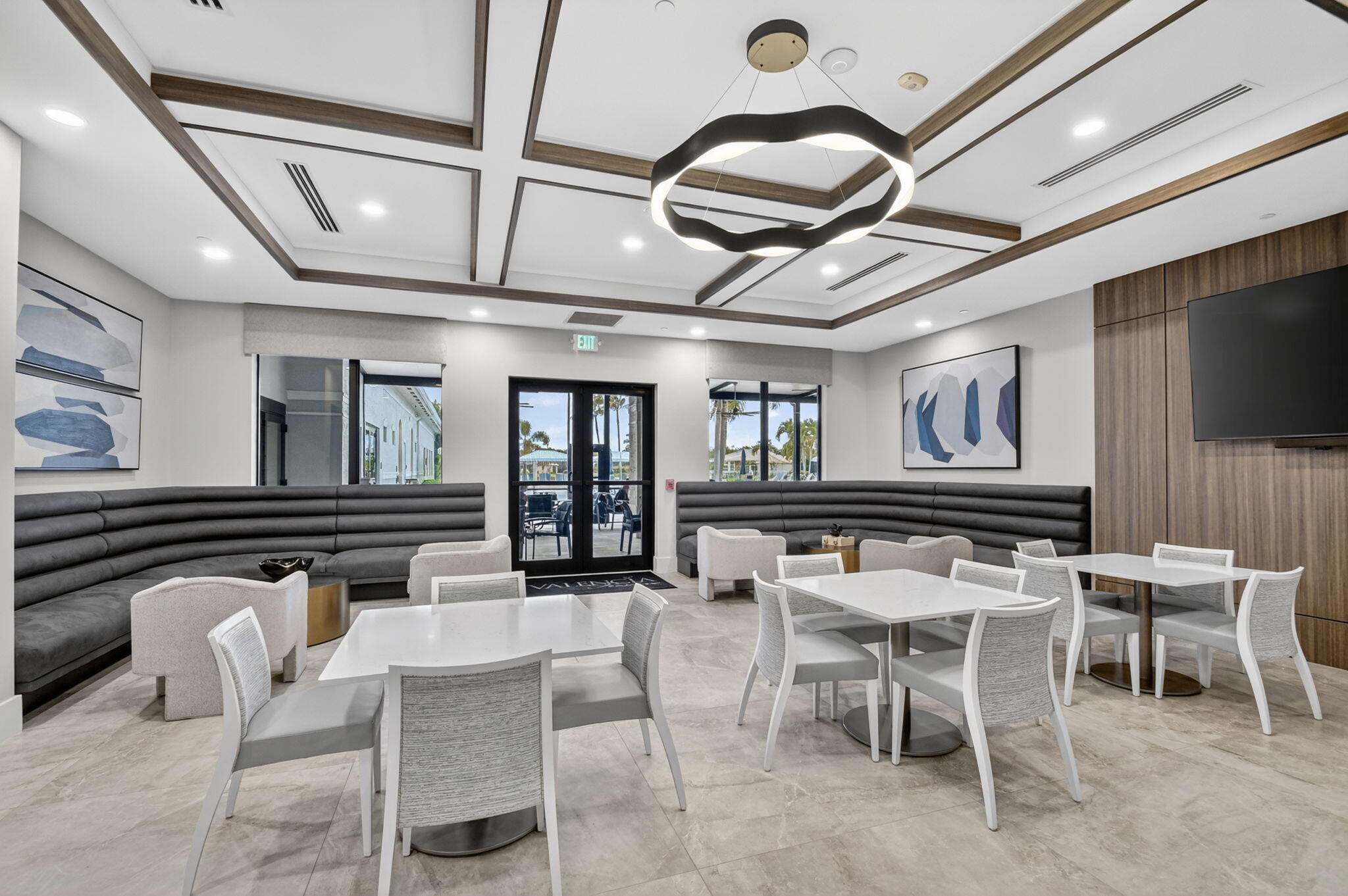 9119 Ribbons Ridge Point Boynton Beach, FL 33473 - Photo 68 of 91 a dining hall with couches a dining table and chairs with wooden floor