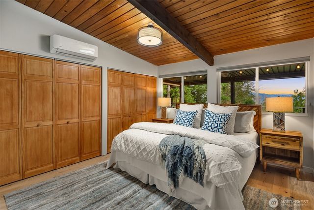a bathroom with a granite countertop sink toilet a mirror and shower