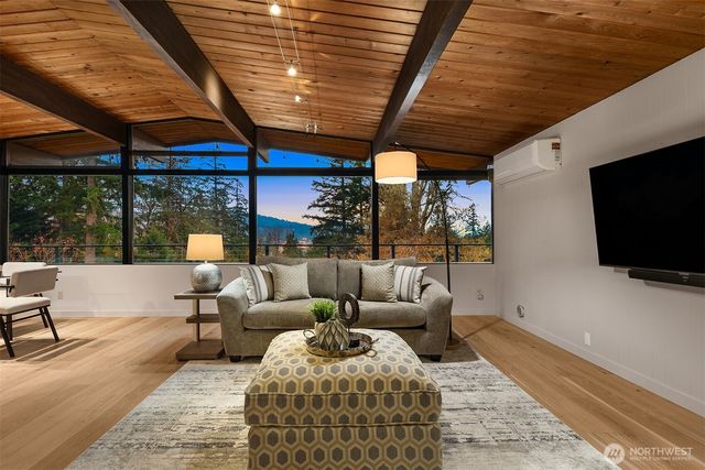a living room with furniture a flat screen tv and a table