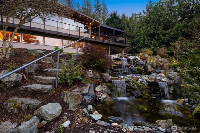 a view of a fire pit with large trees