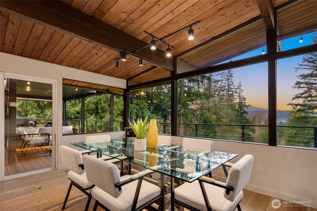 a view of a patio with lawn chairs and wooden floor