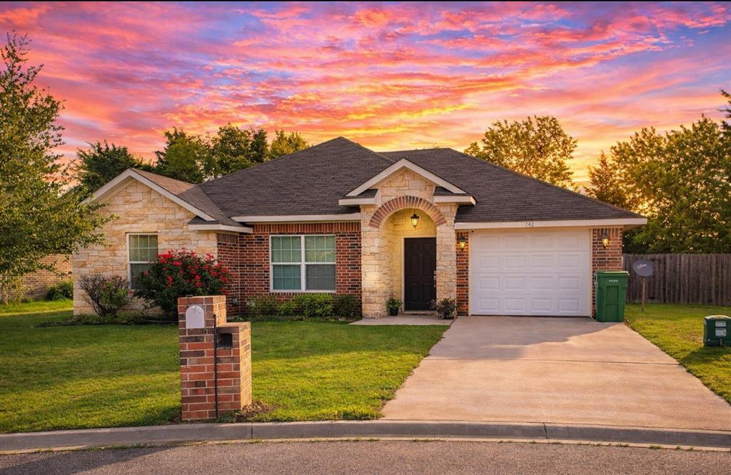 142 Tomahawk Drive Waco, TX 76705 - Photo 1 of 14 a front view of a house with a yard and garage