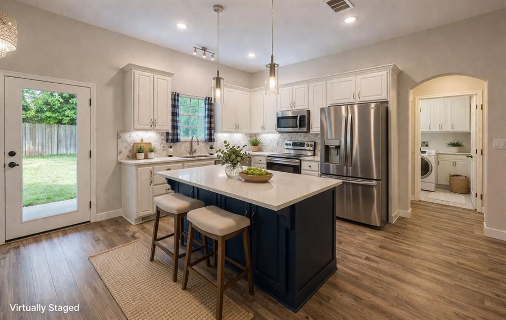 142 Tomahawk Drive Waco, TX 76705 - Photo 4 of 14 a kitchen with stainless steel appliances a dining table chairs refrigerator and microwave