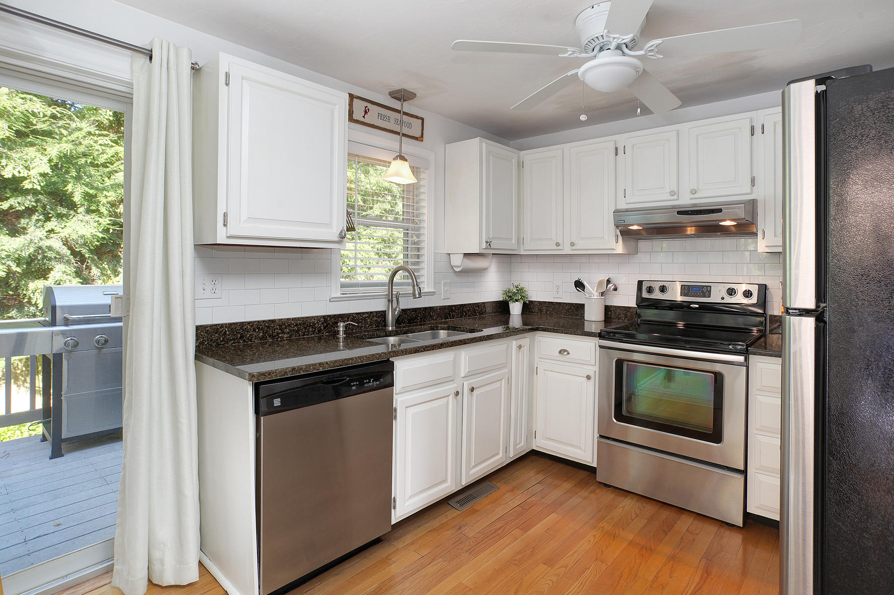 132 Harbor Hills Road Centerville, MA 02632 - Photo 9 of 31 a kitchen with stainless steel appliances a stove a sink and a microwave
