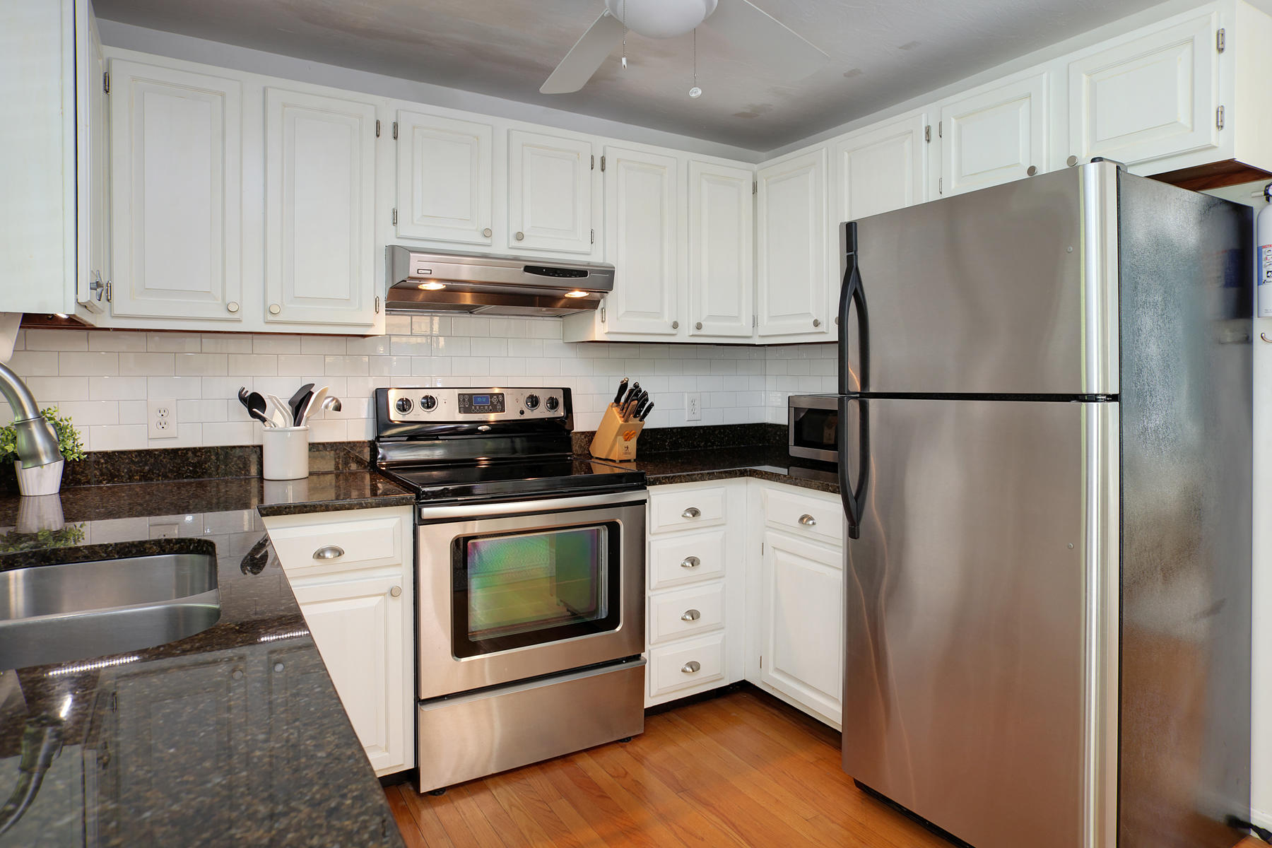 132 Harbor Hills Road Centerville, MA 02632 - Photo 10 of 31 a kitchen with a refrigerator sink and cabinets
