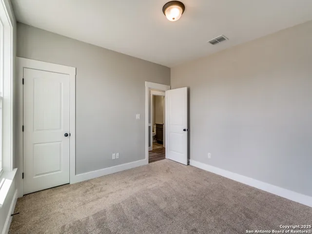 an empty room with closet area